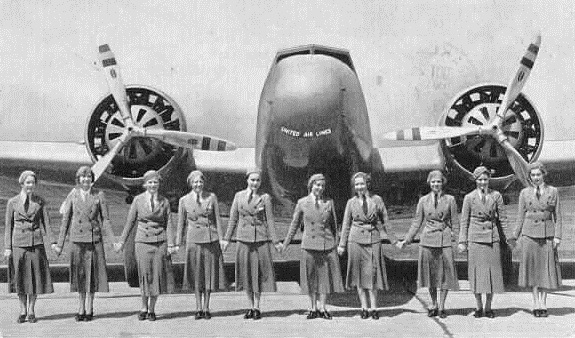 A group of people standing in front of an airplane

Description automatically generated with medium confidence